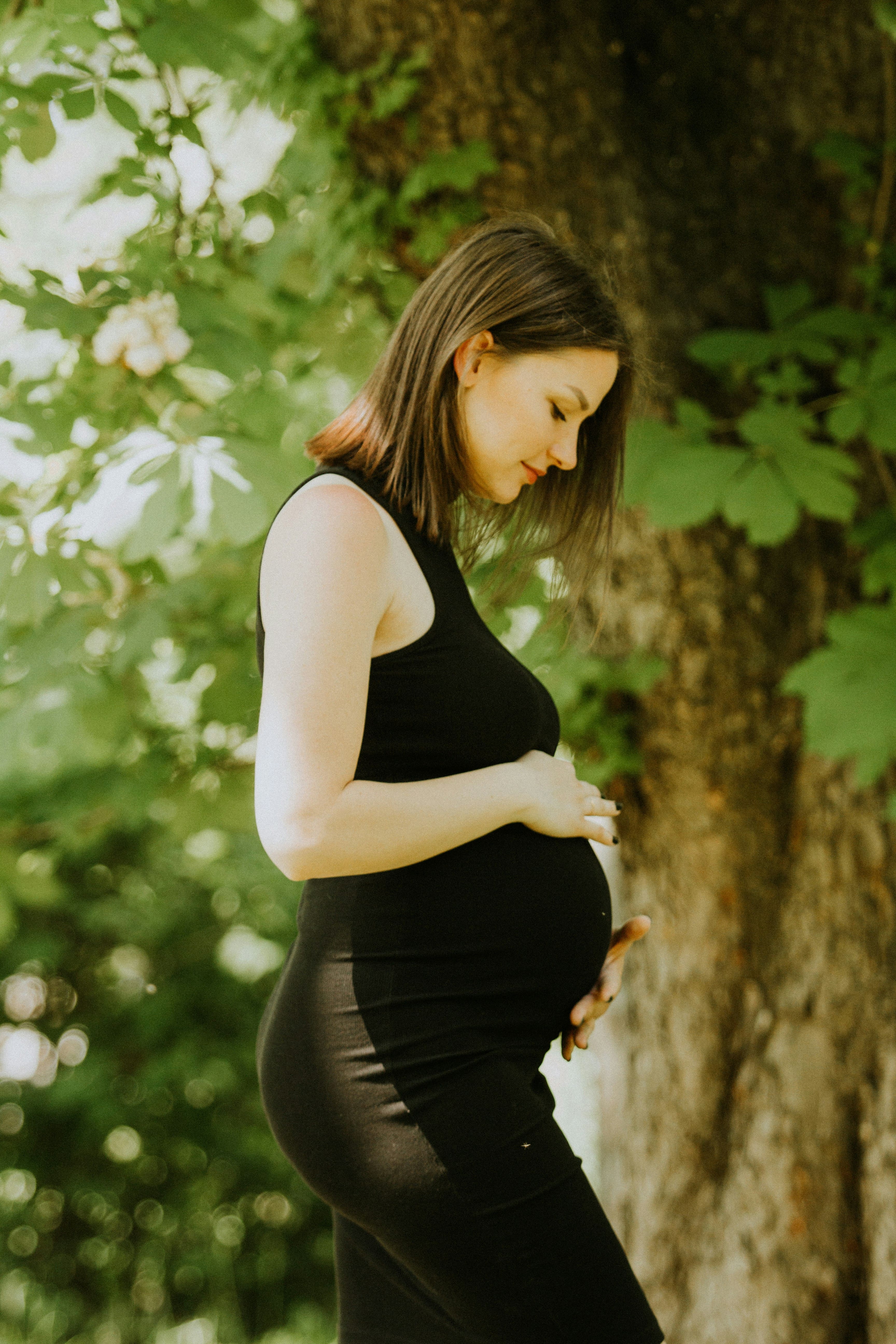 Pregnant woman practicing gentle yoga in a peaceful setting