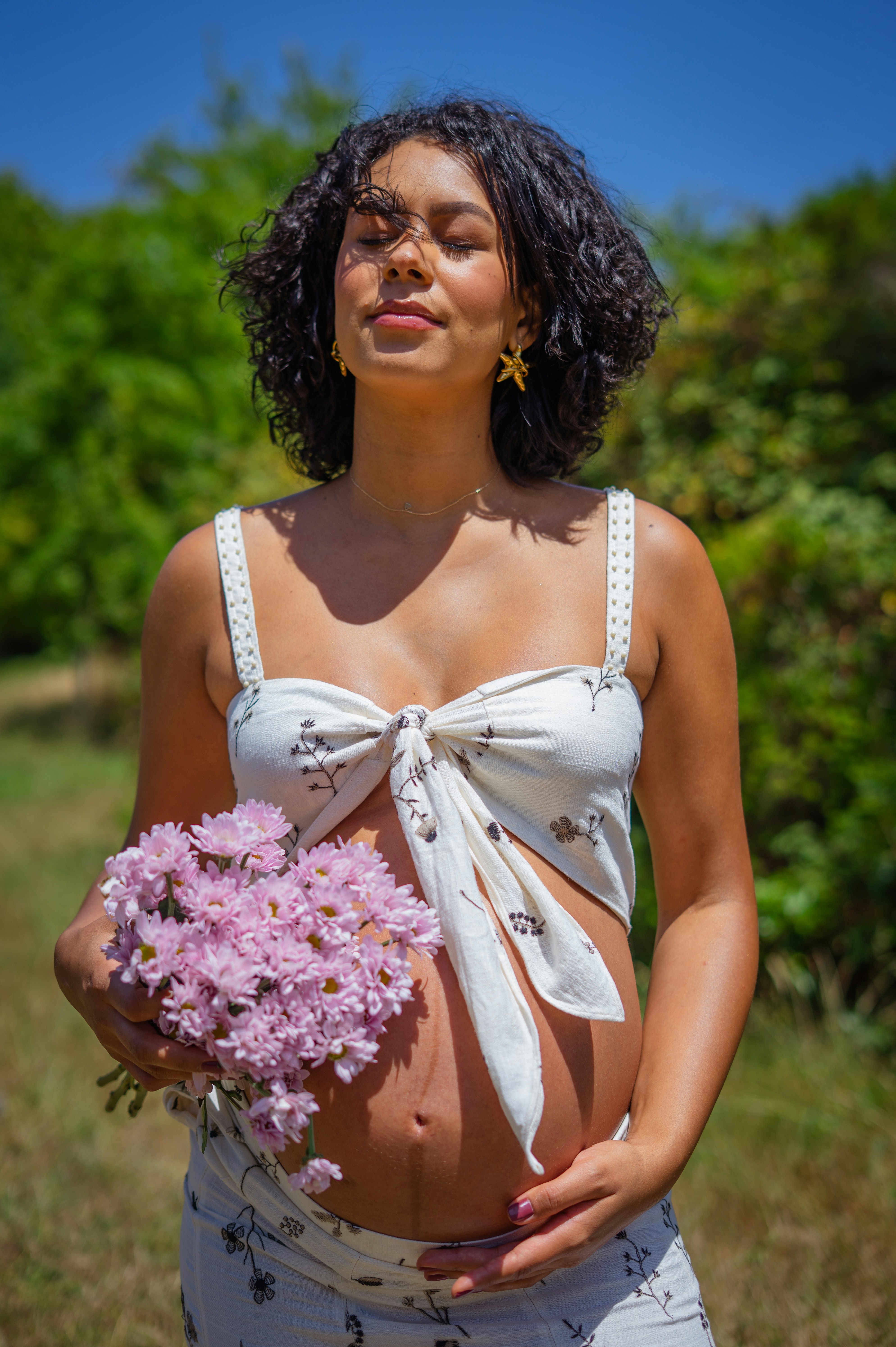 Pregnant woman holding her bump tenderly